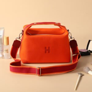 Orange canvas crossbody makeup bag with detachable strap